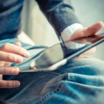 close up hands multitasking man using tablet, laptop and cellhpo